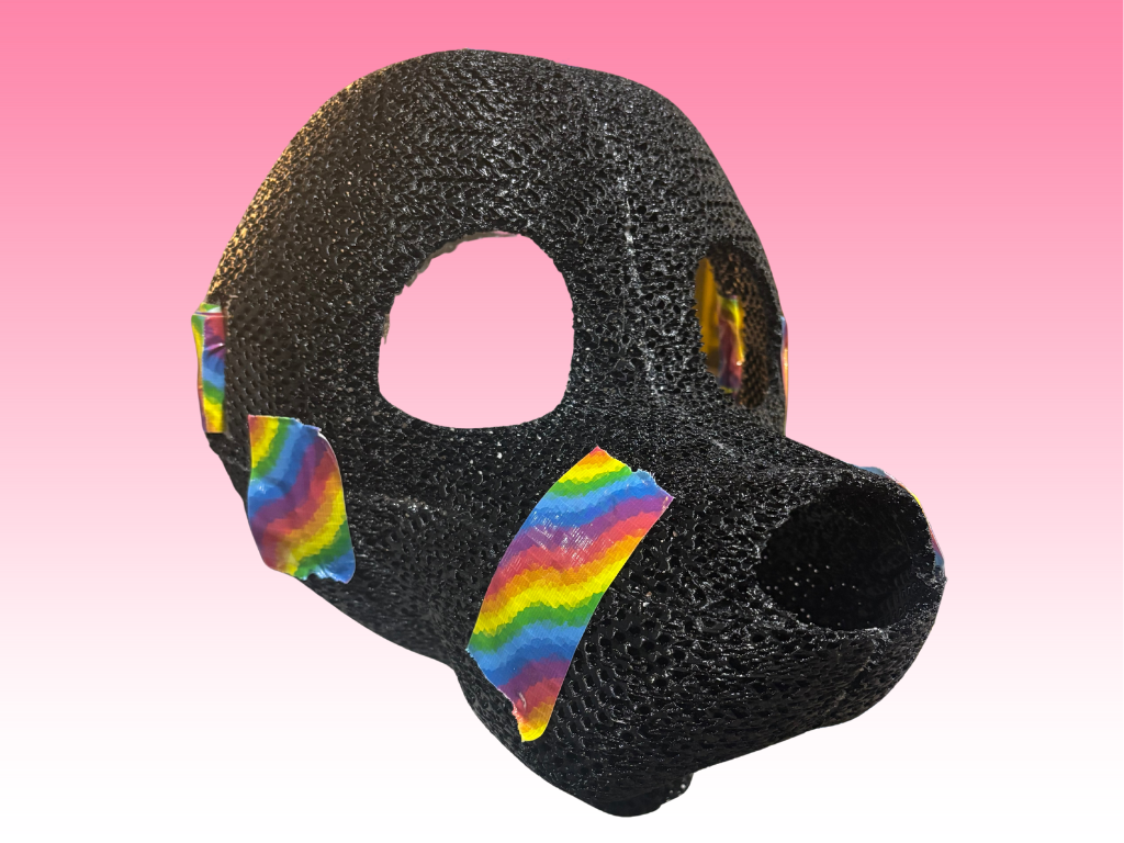 Black textured object with rainbow accents on a pink background